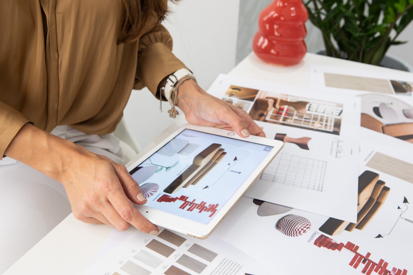 María Alejandra working with a tablet and design samples